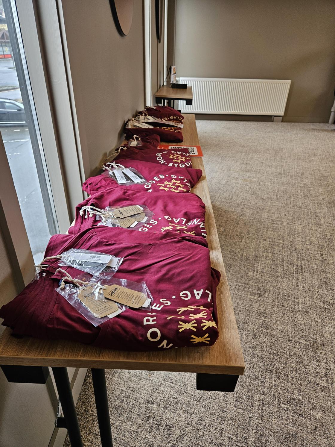 Raude t-skjorter på eit bord