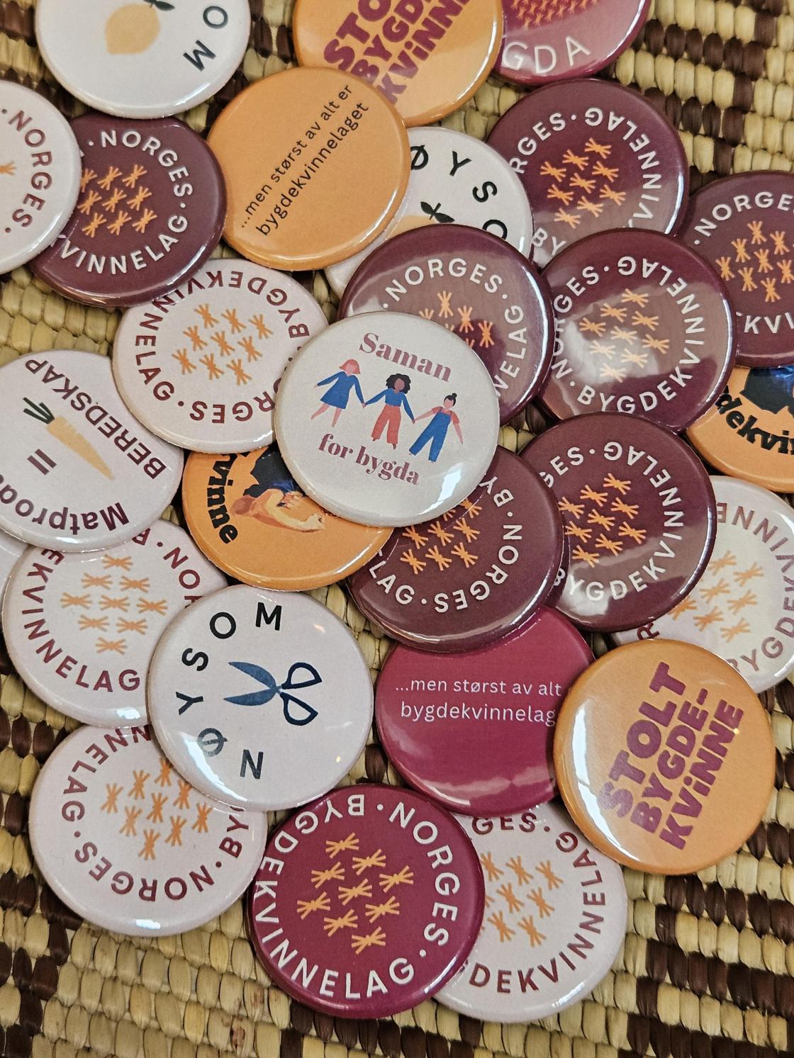 Buttons med slagord for bygdekvinnelaget i ulike fargar
