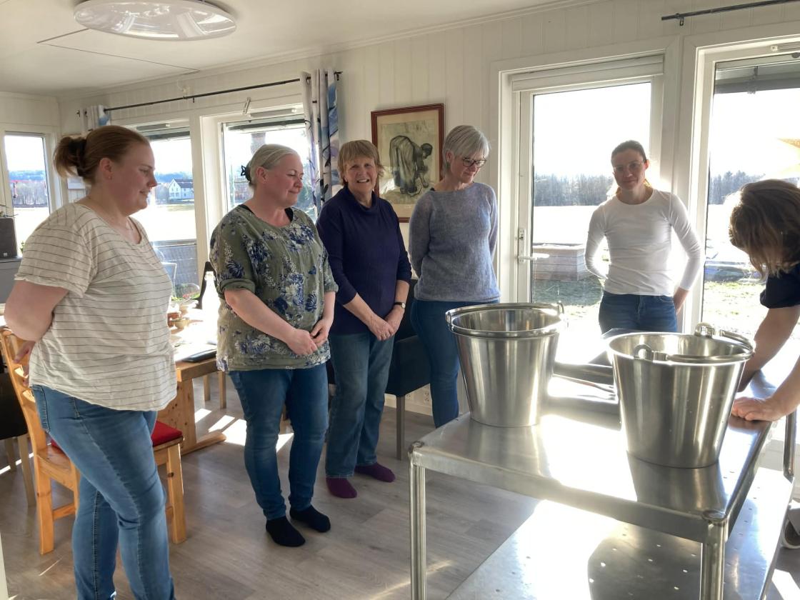 Kursdeltagere står i ring og lytter