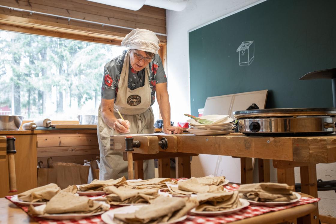 Marie Skjellerud bedømmer hvordan byggsortene fungerte i potetlomper og flatbrød. Foto: Øyvind Strand Endal.