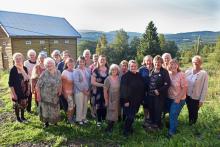 Feststemte kvinner samlet til 70 årsfeiring for Torpa Bygdekvinnelag – her på Haugtun med bygda og Synnfjellet i bakgrunnen. Foto: Halgrim Øistad.